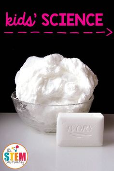 a bowl filled with whipped cream next to a bar of soap on top of a table