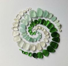 green and white sea glass arranged in a spiral