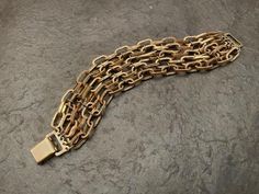 This bracelet is so striking!   It's about 1 1/4" wide and 7" long.   Made of goldtone metal etched links.  Hinged clasp. Milwaukee Wi, Multi Strand, Chain Link Bracelet, Metal Chain, Link Bracelets, Milwaukee, Chain Link, Cuff Bracelet, Gold Tones