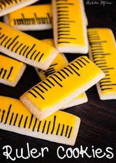 yellow and black decorated cookies with the words ruler cookies