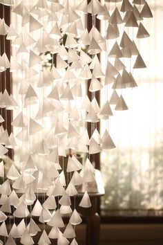 a close up of a wind chime hanging from a window