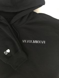 This listing is for ONE custom embroidered UNISEX hoodie. Please add twice to cart for two hoodies. The date is on the left chest and the initial and heart is on the right sleeve. If you would like different placements for these designs please message us on Etsy. The more text you add the smaller the text will be. If you do not write what thread color you would like in the personalization box we will use a thread color that compliments the hoodie color. Interested in a different hoodie and/or thread color? Message us on Etsy to request a color. Please see the size chart in the product listing photos to determine the best size for you. This custom embroidered hoodie makes a great couples gift for many occasions and holidays - anniversary, engagement announcement, bachelorette gift, wedding, Black Hoodie With Letter Embroidery For Streetwear, Streetwear Hoodie With Embroidered Text, Hooded Hoodie With Embroidered Text For Streetwear, Black Hoodie With Embroidered Graphics, Sporty Hooded Hoodie With Custom Embroidery, Black Crew Neck Hoodie With Embroidered Text, Winter Black Hoodie With Embroidered Text, Black Crew Neck Hoodie With Letter Embroidery, Casual Black Hoodie With Embroidered Text