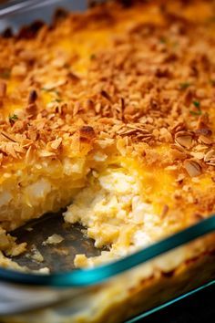 a casserole dish with a piece taken out of it's crust and topped with coconut flakes