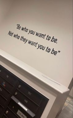 there is a sign on the wall that says be who you want to be