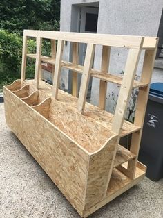 a wooden bench sitting next to a trash can