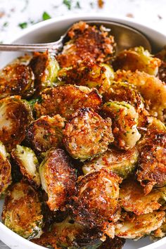 closeup of cooked brussel sprouts with seasoning on the side