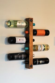 a wooden wine rack with six bottles on it's sides and four empty ones in the middle