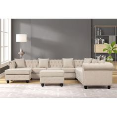 a living room scene with focus on the sectional sofa and footstools in the middle