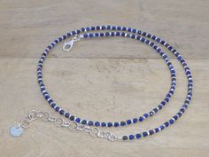 A lovely and luminous choker in natural stone and elements in 925 and 970/1000 silver. Pretty little round faceted lapis lazuli stones of around 2mm mixed with 970/1000 silver washers, these are Karen Hill Tribe elements made in an artisanal way. The various connecting elements - chain, carabiner, sequin - are in 925/1000 silver. Hallmark visible on the back of the sequin. Wear alone or in combination with other necklaces, a great choice in the shop. Length 40cm + 5cm chain. Delivered in a track Silver Jewelry With Faceted Beads Made Of Lapis Lazuli, Silver Jewelry With Faceted Beads In Lapis Lazuli, Blue Choker, Lapis Lazuli Jewelry, Lapis Lazuli Stone, Real Stone, Organza Gift Bags, Stone Bracelet, Lapis Lazuli