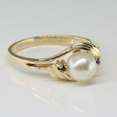 10K Yellow Gold Pearl Sapphire Accent Ring, bypass style, split shank, 2 small sapphire accents, 6mm white pearl with green and pink highlights, .25 inch across ring, Ring size 6.5, Circa 1970, 2.5 grams SKU # BB272R04 Most rings are sizable for a small fee. If the ring you are considering is the incorrect size contact us for a quote. This listing contains photographs of the actual item you will receive. Our items are in excellent condition with little or no signs of wear and many are one of a k Senior Ring, Senior Rings, Gold Coin Ring, Pearl Rings Vintage, Ring Inspo, Pearl Rings, Cute Engagement Rings, Gold Pearl Ring, Future Engagement Rings