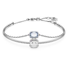 Enjoy two styles in one with this fascinating Chroma bangle. The rhodium plated design features a solid band embellished with clear crystals and a clear stone at the center, while the soft chain holds a rectangular-shaped Swarovski Zirconia in blue. Both stones are surrounded by clear square-cut crystals on the sides for added radiance. The piece has a lobster closure with an elongation for an adjustable fit. Inspired by drops of light, this beautiful bangle is the epitome of understated glamour Blue Crystal Bracelet, Premier Jewelry, The Bangles, Adjustable Bangle, Elegant Bracelet, Clear Stone, Clear Crystals, Strand Bracelet, Swarovski Jewelry