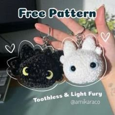 two keychains with cats on them in the palm of someone's hand