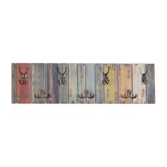 an assortment of metal hooks mounted to the side of a wooden wall with multicolored boards