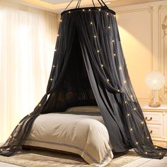 a black canopy bed with stars on it