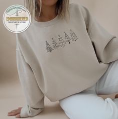 Embroidered Pine Tree Sweatshirt, Embroidery Christmas Tree Hoodie, Christmas Kids Sweatshirt, Xmas Tree Sweatshirt, Pine Tree Hoodie ---------- Product ---------- * Heather CVC Colors: 50% cotton, 50% poly, * Plain colors:100% cotton * Rolled sleeves in pictures is for styling purposes only. * Colors may seem different on the computer screen, or in the lighting in which the picture was taken. * Each item is sold separately. * Double-needle stitching throughout * Seamless collar * We use direct Holiday Embroidered Casual Sweatshirt, Casual Embroidered Holiday Sweatshirt, Casual Holiday Embroidered Sweatshirt, Casual Christmas Sweatshirt With Custom Embroidery, Embroidered Long Sleeve Christmas Sweatshirt, Casual Christmas Sweater With Embroidery, Winter Hoodie With Crew Neck And Machine Embroidery, Long Sleeve Tops With Machine Embroidery For Winter, Embroidery Christmas Tree