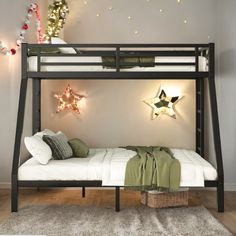 a bunk bed with two stars on the wall above it and a white mattress underneath