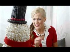 a woman pointing at a snowman made out of popcorn