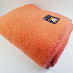 three orange towels folded on top of each other