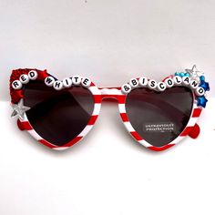 Disco Biscuits  RED WHITE & BISCOLAND Festival ready with these patriotic heart shaped sunglasses! -heart shape glasses -dark lenses. American flag print.  -hand embellished with rhinestones and letter beads.  Made with love  ◡̈ see you on the dance floor! **making more of these soon, message me to save some money if you need a few to share with your crew OR for any custom additions! Summer Beach Sunglasses With Heart Print, White Heart-shaped Sunglasses For Summer, Fun Summer Sunglasses With Heart Print, White Festival Sunglasses For Summer, Summer Festival White Sunglasses, White Heart-shaped Sunglasses For Beach, White Sunglasses For Summer Festival, White Heart-shaped Beach Sunglasses, Fun Heart-shaped Sunglasses For Summer