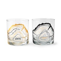 two glass tumblers with different designs on them