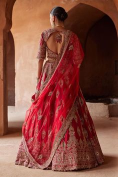 Cardinal red attached cancan lehenga with gold dabka, zari, sequin, bead, crystal embroidery in floral pattern. Paired with embroidered padded blouse and dupatta.
Components: 3
Pattern: Embroidery
Type Of Work: Dabka, zari, sequin, bead, crystal
Neckline: Notched
Sleeve Type: Three quarter
Fabric: Raw Silk, Net
Color: Red
Other Details: 
Lehenga:
Attached cancan
Floral pattern
Length: 45 inches
Blouse:
Padded
Bead drops on hem
Back cut-out
Tassel detailing at the back
Dupatta:
Embroidered scallo Coral Ombre, Crystal Work, Indian Women Painting, Raw Silk Lehenga, Crystal Embroidery, Coral Blouse, Bridal Lehenga Red, Padded Blouse, Indian Wedding Wear