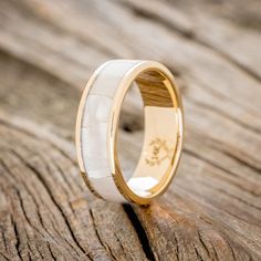 a wooden ring with antler inlays on it