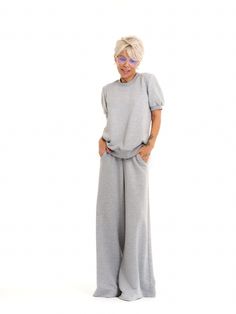 Take your athleisure looks to the next level. Our sweatsuit set combines the comfort of casual dressing with eye-catching streetwear elements for an elevated everyday look. FEATURES:A grey sweatsuit set with a pleated tulle panel at the back. The top has short puff-sleeves. The bottoms have an elastic waistband and functional side pockets.100% Handmade. SIZE & FIT: Fit: A relaxed fit with room to moveModel is wearing size Small or S/M View our SIZE CHART before ordering MATERIALS & CARE: Content: Viscose Care: Machine wash on cold (30ºC) with a mild detergent. SHIPPING: Made to order, processing time is 15 working days This item will be shipped via DHL Gray Tracksuit With Pockets For Loungewear, Gray Loungewear Sets With Pockets, Casual Gray Relaxed Fit Sets, Casual Gray Sets With Relaxed Fit, Sporty Gray Loungewear Sets, Gray Athleisure Loungewear Sets, Gray Athleisure Sets For Loungewear, Gray Relaxed Fit Loungewear Set, Fall Gray Relaxed Fit Tracksuit