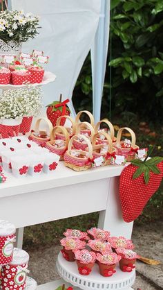 a table topped with lots of cupcakes and cakes