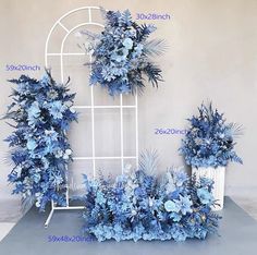 blue flowers are arranged in front of a white trellis with the names below it