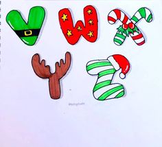 christmas stickers are arranged in the shape of letters and hats on a sheet of paper