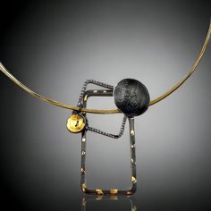 Unusual and bold but very lightweight, this steel necklace is gorgeous in deep, luscious black with accents of 24K gold. Gold is applied in the ancient Korean technique of Keum Boo. Stainless steel multi-cable neck wire in shades of black, silver and gold compliments the colors of this necklace and is incorporated into the design itself. Twist and turn locking mechanism. 2 1/4" long pendant, 1 1/2' in width with an 18" neck wire. This necklace is available exclusively through the Chihuly Collect Black Metal Jewelry With Unique Design, Contemporary Black Jewelry With Oxidized Finish, Unique Design Black Metal Jewelry, Elegant Black Hand Forged Necklace, Modern Black Necklace With Oxidized Finish, Modern Oxidized Gold Necklace, Modern Gold Necklace With Oxidized Finish, Unique Hand Forged Black Necklace, Hand Forged Black Metal Jewelry