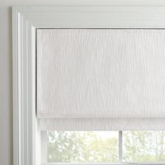 an open window with white roman shades