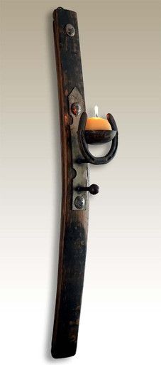 a candle that is sitting on top of a doorknob with an iron handle