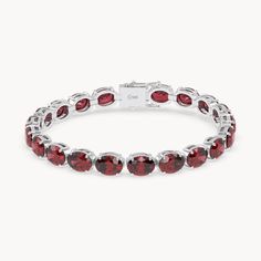 The Rouge Tennis Bracelet celebrates the passionate power of the ruby, with its deep red color reminiscent of a glowing fire. Crafted from 14kt recycled gold, the bracelet is set with oval cut rubies elegantly held in prong settings. With an impressive total carat weight of 36ct. and an intense red hue, each stone embodies passion and strength. This piece, with a width of 6 mm, is a true eye-catcher and a symbol of the fiery elegance of rubies. Red Oval Diamond Gemstone Bracelet, Formal Ruby Oval Tennis Bracelet, Classic Red Oval Diamond Bracelet, Red Oval Diamond Classic Bracelet, Red Oval Classic Diamond Bracelet, Oval Ruby Tennis Bracelet For Formal Occasions, Oval Ruby Gemstone Tennis Bracelet, Oval Ruby Diamond Bracelet, Red Oval Tennis Bracelet Fine Jewelry