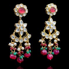 Crafting timeless masterpieces to perfection for eternity! Statement heritage earrings created with kundan stones and beautiful ruby beads. Approximate earrings length is 1.75". Gold-plated on high-quality brass as base metal. In-stock & ready-to-ship. *Please Note: We use faux stones and beads in all of our jewelry. Red Earrings For Diwali Rituals, Kundan Earrings With Meenakari For Rituals, Elegant Meenakari Earrings For Rituals, Traditional Red Earrings For Rituals, Bollywood Meenakari Earrings For Rituals, Kundan Jeweled Chandelier Earrings Temple Style, Kundan Jeweled Earrings For Diwali, Festive Kundan Earrings For Rituals, Temple Style Jeweled Kundan Chandelier Earrings