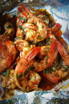 cooked shrimp with herbs and spices in foil