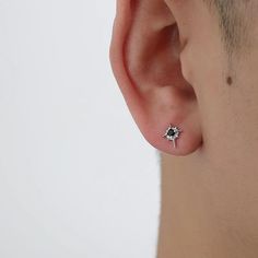 a man wearing an earring with a star on it