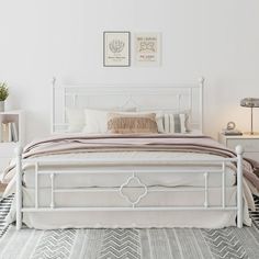 a white bed sitting in a bedroom on top of a rug