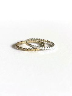 Great on its own, or for stacking. One of our most popular styles! Adjustable Stackable Midi Rings Fine Jewelry, Dainty Stackable Round Band Jewelry, Dainty Tarnish-resistant Round Stackable Rings, Dainty Stackable Rings Tarnish Resistant, Dainty Tarnish-resistant Stackable Rings, Tiny 14k Gold Round Midi Rings, 14k Gold Midi Rings For Everyday, Stacked Rings In 14k Gold As Gift, Adjustable 14k Gold Midi Rings