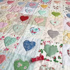 a quilt with hearts on it is laying on the floor