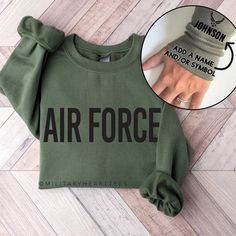 Pictured above in the sweatshirt color Military Green with Black colored design print. See all shirt details in the listing photos. FIND THE T-SHIRT VERSION HERE:  https://www.etsy.com/listing/1365809282/air-force-shirt-with-name-personalized?click_key=72a2a5f948f583d5ef656947c6d9d5f05ab1bbff%3A1365809282&click_sum=0dbfa674&ref=shop_home_active_1&sts=1 Please read the FAQ's & POLICIES section before ordering. Long Sleeve Fleece Tops With Screen Print, Graphic Print Fleece Crew Neck Top, Fleece Crew Neck Top With Letter Print, Fleece Tops With Letter Print And Crew Neck, Green Letter Print Crew Neck Sweats, Green Fleece Tops With Letter Print, Green Fleece Top With Letter Print, Air Force Sweatshirt, Air Force Shirt