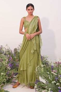 Green pre-stitched saree with ruffle trims. Paired with a padded blouse with floral hand embroidered straps. - Aza Fashions Elegant Pre-draped Saree For Spring, Fitted Georgette Pre-draped Saree For Spring, Fitted Pre-draped Saree For Festive Spring Occasions, Fitted Spring Festive Pre-draped Saree, Fitted Festive Spring Pre-draped Saree, Green Fitted Saree For Spring, Fitted Green Pre-draped Saree With Ruffles, Green Fitted Pre-draped Saree For Summer, Fitted Green Pre-draped Saree For Summer