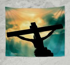 a person holding a cross in front of a cloudy sky with the sun behind them