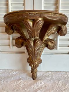 an ornately decorated table in front of white shutters