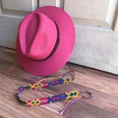 Stay stylish in our wonderfully colorful Mexican straw hats, ideal for any sunny day occasion. Colorful braided headpiece is included, as shown in the picture. Can be used to decorate the hat or just around your head by itself. MADE IN MEXICO By: Mexican Artisans For: Women Size: Large (23.5") Color: Magenta Details: Material: Palm Straw Removable braided yarn headpiece Leather Band Inner elastic band Contact us for more details PLEASE READ BEFORE PURCHASE: The picture is an ACCURATE REPRESENTAT Pink Straw Casual Hat, Pink Casual Straw Hat, Casual Pink Straw Hat, Pink Wide Brim Straw Sun Hat, Adjustable Pink Straw Sun Hat, Adjustable Pink Straw Hat For Summer, Adjustable Pink Straw Hat, Pink Summer Fedora Panama Hat, Pink Flat Brim Panama Hat For Summer