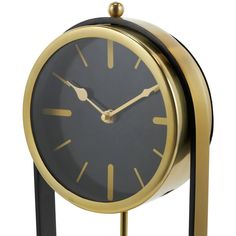 a black and gold clock on a stand