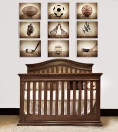 a baby crib with pictures on the wall above it