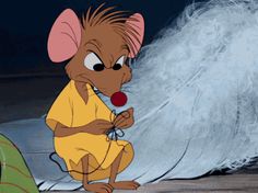 a cartoon mouse is standing in front of a feathered wall and looking at something