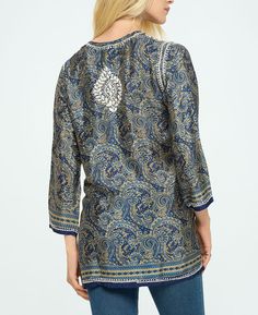 Featuring opulent patterns in rich colors, the Midnight Desert tunic showcases traditional Indian handicrafts with embroidered florals at the neck and hem. Topped with a buttoned henley neckline and side slits, it's made from a lux poly-silk blend. Embroidered Indian-style tunic Made from a polyester and silk blend 72% – Polyestere, 28% – Silk Henley neckline, vented hem Shades of midnight blue with sand-colored embroidery Made in India Garment Flat Measurement (Inches): Please note that the mea Traditional Multicolor Embroidered Tunic Top, Luxury Block Print Women's Tunic, Bohemian V-neck Tunic With Resham Embroidery, Bohemian Semi-stitched Jamawar Embroidered Fabric, Luxury Embroidered V-neck Tunic, Linen Clothes, Scarf Shawl, Midnight Blue, Women Collection