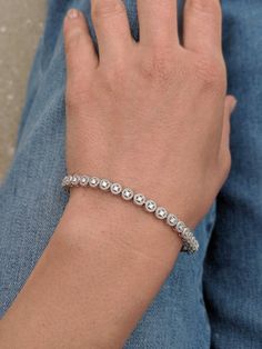 We took a classic tennis bracelet and added vintage charm with delicate milgrain detailing. The bracelet is finished with a box clasp with locking hinge for added security. This bracelet is fully customizable. If you prefer 18k gold or platinum, different dimensions, different quality diamonds or moissanites or colored gemstones, please contact us: http://etsy.me/1231fkN Details: - Solid 14k yellow or white gold - Bracelet is 7 inches in length. For different lengths, please contact us. - SI+G/H Silver Dainty Hand-set Tennis Bracelet, Classic Formal Beaded Bangle Bracelets, Classic Beaded Bangle Bracelets For Formal Occasions, Classic Bezel Setting Tennis Bangle Bracelet, Timeless Tennis Bracelet With Bezel Setting As Gift, Classic Sterling Silver Diamond Cut Bangle Bracelet, Classic Sterling Silver Diamond Cut Bangle, Classic Sterling Silver Hand Set Bangle, Classic Hand Set Sterling Silver Bangle